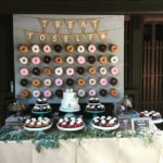 A Quinceanera celebration with a table full of donuts covered in frosting