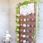 A display of doughnuts on a wooden board for a Quinceanera celebration