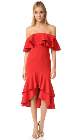 A woman wearing a red Quinceanera dress and sandals