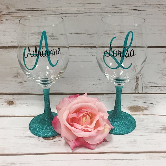 Quinceanera wine glasses on a table with a rose