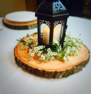 Quinceanera centerpiece wood slices with a candle on top