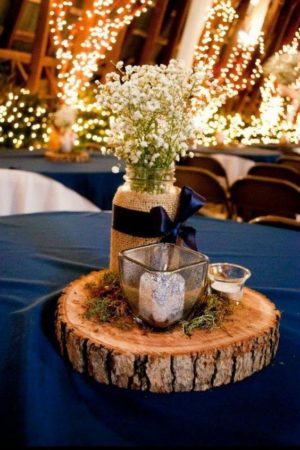 Quinceanera centerpiece table, featuring a mason jar filled with baby's breath