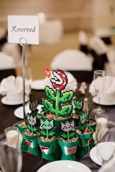 Quinceanera decorations: A table decorated with cups filled with food