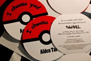 A close up of a compact disc Pokémon Sword and Shield with a poke ball on it. It's a birthday card for a Quinceanera celebration.