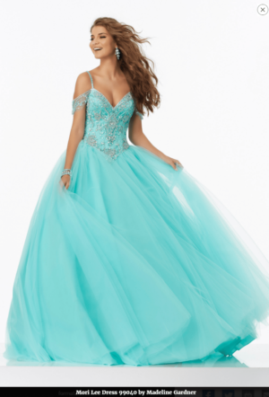 A woman posing for a picture wearing a blue Quinceanera gown