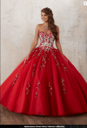 A woman in a red Quinceañera dress posing for a picture