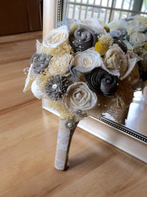 Floral design, a bouquet of flowers sitting on top of a wooden floor for a Quinceanera celebration