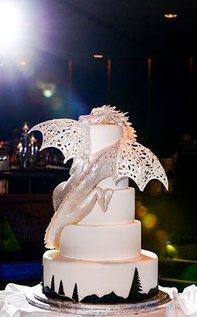 Quinceanera cake, a fantasy dragon cake with a white wedding cake on top