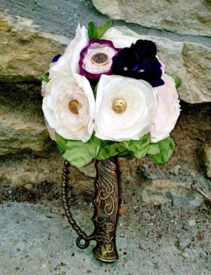 A beautiful Quinceanera bouquet consisting of white and purple flowers, arranged in a vase.