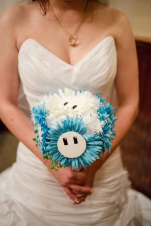 Quinceañera woman in a quinceanera themed wedding dress holding a bouquet of flowers
