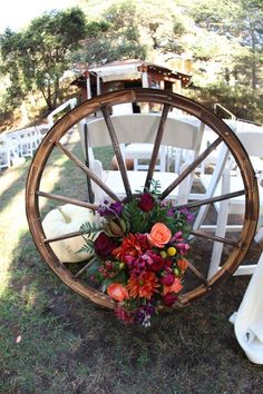 Quinceanera, a wagon wheel with a bunch of flowers on it