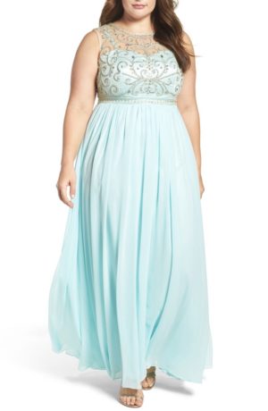 A beautiful woman wearing a long blue Quinceañera dress on her special day