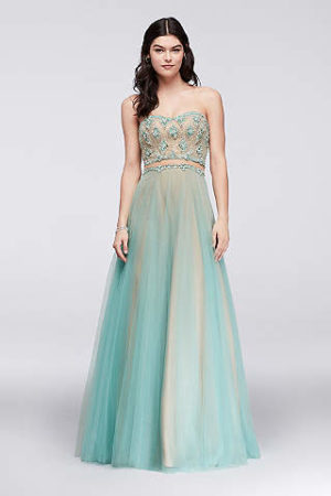 A Quinceanera gown worn by a woman, featuring a blue and green dress.