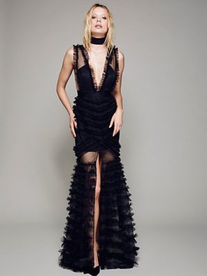 A Quinceanera fashion model wearing a black gown posing for a picture