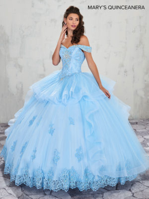Quinceañera dresses, a woman in a light blue dress posing for a picture
