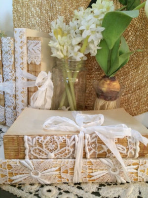 Floral design and a stack of books sitting on top of a table at a Quinceanera celebration