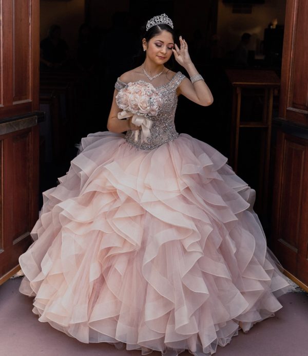 Quinceanera gown, a woman in a Quinceanera dress standing in a doorway