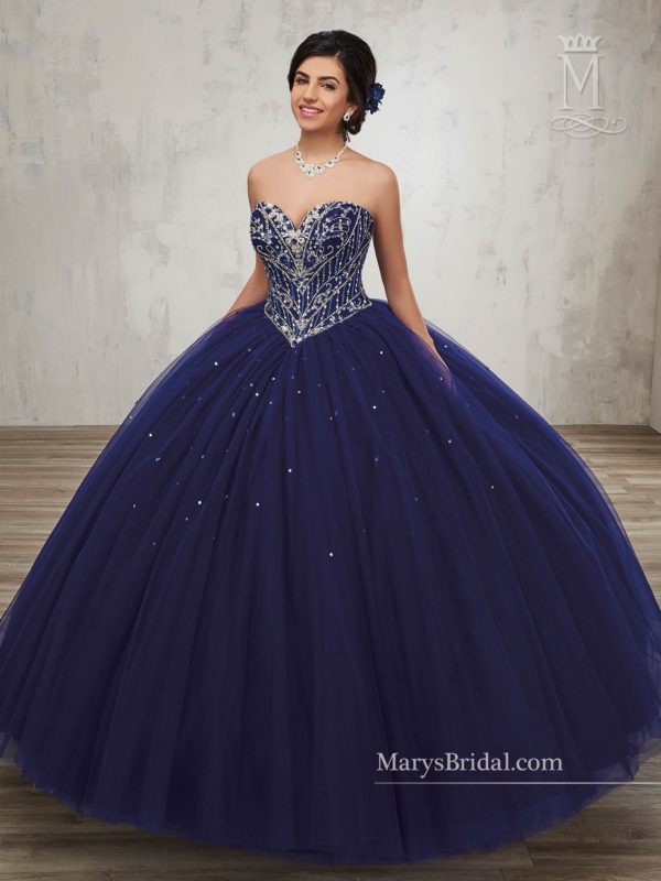A woman in a Quinceanera dress, inspired by Beauty and the Beast, posing for a picture in a ball gown