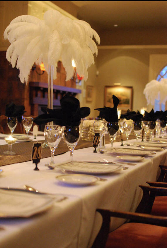 A long table is set for a formal Quinceanera dinner in a function hall.