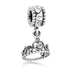 A Quinceanera themed image featuring a Pandora my princess charm. The charm is made of silver and has a crown on it.