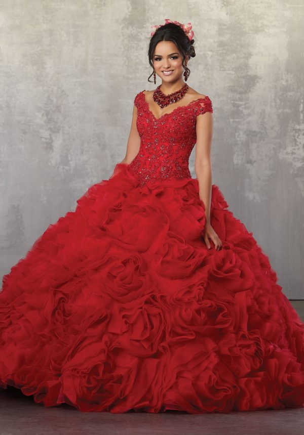 A woman in a red 2018 Quinceanera dress posing for a picture