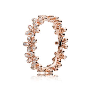 A Quinceanera image featuring a body jewelry Earring and a rose gold ring with diamonds.