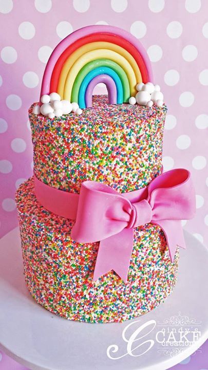 A Quinceanera cake with unicorn, rainbow, and sprinkles