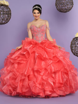 A woman in a red dress posing for a picture wearing a gown Quinceañera dress.