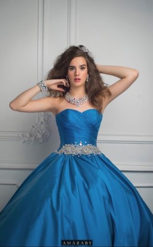 Quinceanera gown, a woman in a blue dress posing for a picture