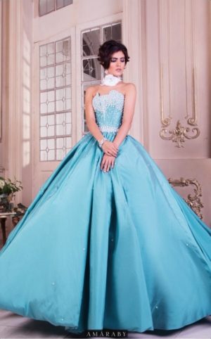 Quinceanera gown, a woman in a blue dress posing for a picture
