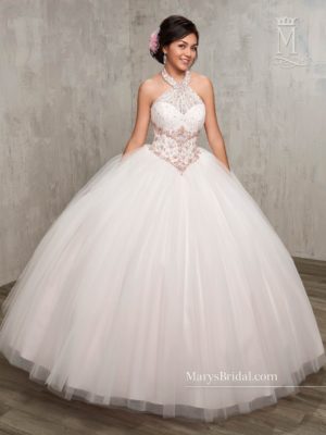 Quinceanera, a woman in a flower girl dress posing for a picture at Mary's Quinceanera