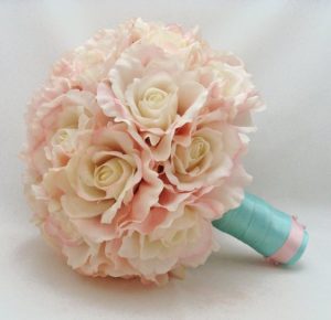 A Quinceanera floral design, featuring a bouquet of pink and white flowers on a white background