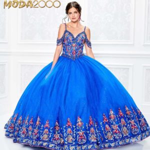 A woman in a blue Quinceañera gown posing for a picture