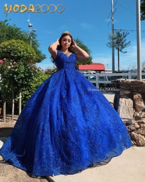Moda 2000 Quinceañera dresses - a woman in a blue dress posing for a picture