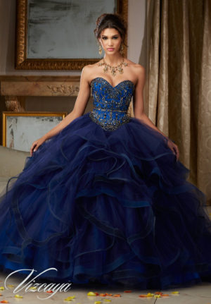Quinceañera dresses - a woman in a blue dress posing for a picture