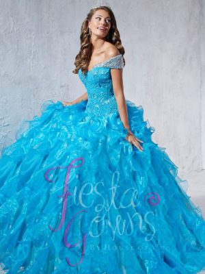 Puffy turquoise Quinceañera dresses, a woman in a blue dress posing for a picture