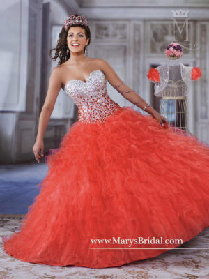 A woman in a red Quinceanera dress posing for a picture, wearing a Quinceanera gown.
