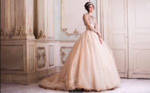 gown Quinceañera dresses, a woman in a Quinceanera dress standing in a room