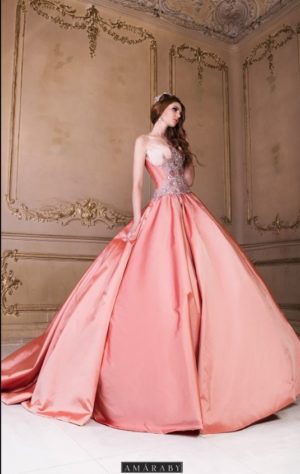 Two women in Quinceanera and wedding dresses standing in front of a mirror