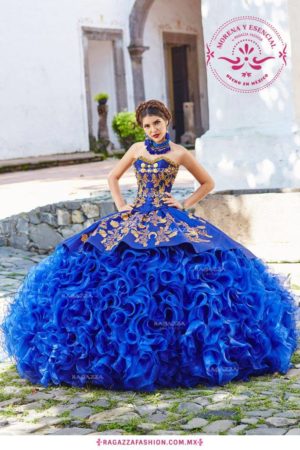 A woman posing for a picture in a puffy royal blue Quinceanera gown