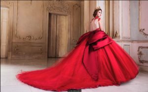 Quinceanera: A woman in a red gown posing for a picture