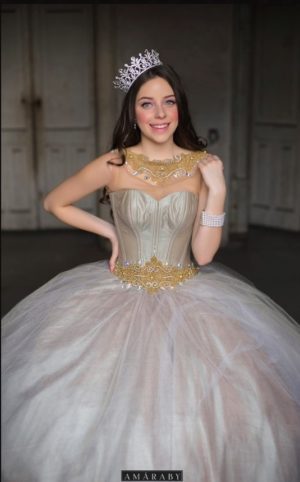 A beautiful young lady wearing a tiara and a Quinceañera gown