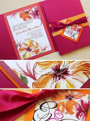 Close up of a Quinceanera invitation with a fuchsia and orange bow