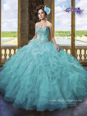 A woman in a blue Quinceañera ball gown posing for a picture, wearing a summer 15 dress