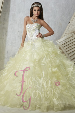 Quinceanera gown, a woman in a yellow dress posing for a picture