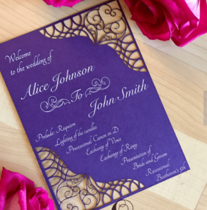 A purple Quinceanera invitation with petal jasmine design, placed on a table.