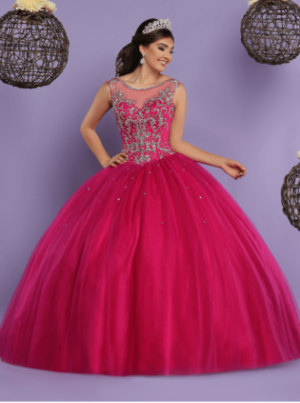 A woman in a pink Quinceanera ball gown posing for a picture