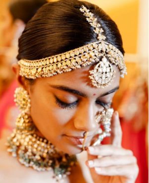 Quinceanera: A woman in a bridal attire with a necklace and earrings