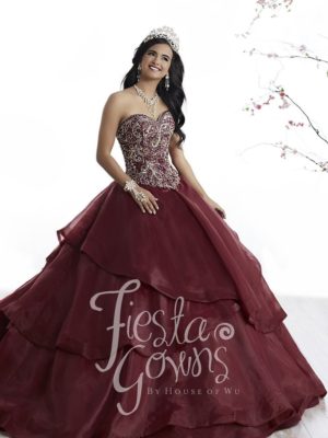 Quinceanera gown, a woman in a red dress posing for a picture