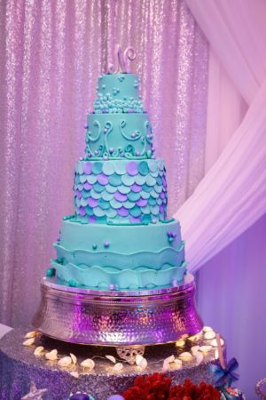 Quinceanera cake, a blue and purple cake on a table